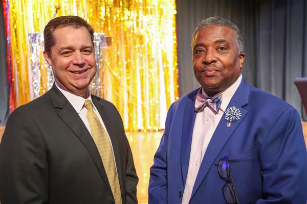 Dr. Gilliam and Derrick Swanson smile to the camera